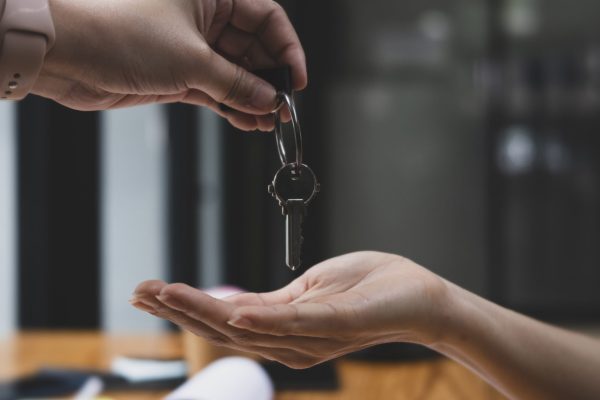 Real Estate Agent Giving Keys from New house to CU